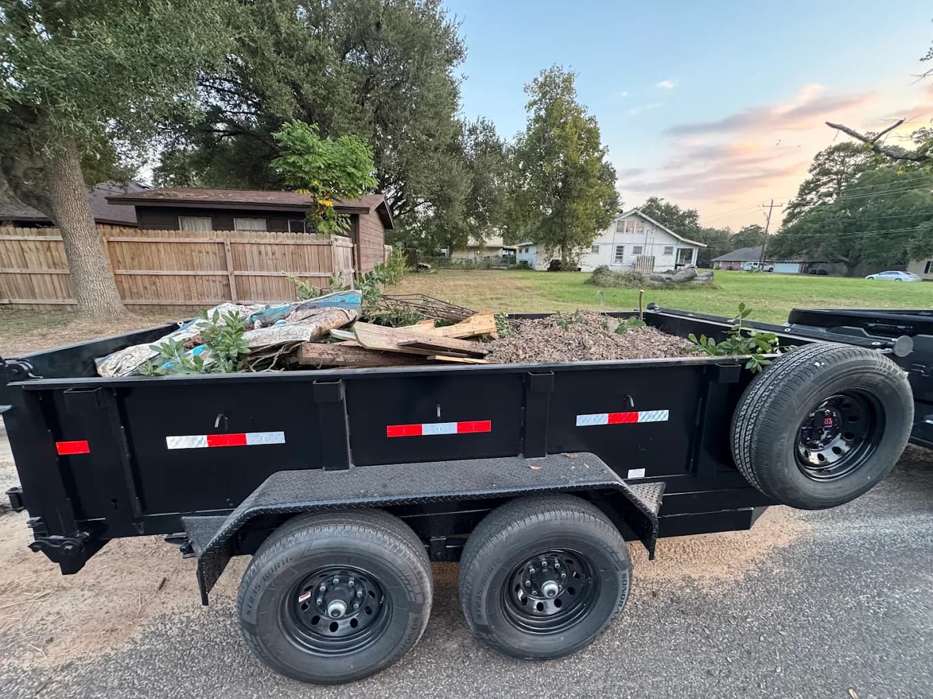 Dump trailer loaded with yard debris for removal
